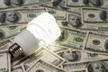 Compact Fluorescent Lightbulb and dollar Royalty Free Stock Photo