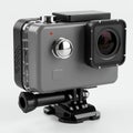 Compact gray action camera with a wide-angle lens on the front and a large silver Royalty Free Stock Photo