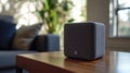A compact, gray speaker designed for audio playback and smart home integration Royalty Free Stock Photo