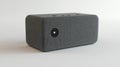 A compact, gray speaker designed for audio playback and smart home integration Royalty Free Stock Photo