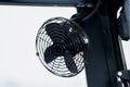 Compact industrial cabin fan with black protective grille and adjustable mounting bracket designed for forklift operator cooling Royalty Free Stock Photo