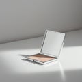 A compact makeup case sits open on a smooth, white surface. It contains two shades Royalty Free Stock Photo