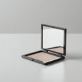 Compact makeup case with a sleek, square design in metallic gray. Open to reveal a Royalty Free Stock Photo