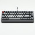 Compact mechanical keyboard with a wired connection featuring predominantly grey