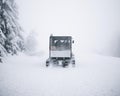 Compact modern snowcat moveing on snow. Royalty Free Stock Photo