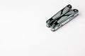 Compact multitool on white background. Tools for cutting, sawing, screwing and filing