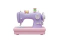 Compact and portable lavender sewing machine with pink base and spools of thread Royalty Free Stock Photo