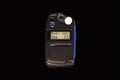 Compact and portable light meter for studio flash  photography isolated on black background. Royalty Free Stock Photo