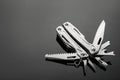 Compact portable metallic multitool on table, space for text Royalty Free Stock Photo