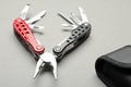 Compact portable multitool and case on light grey background, closeup Royalty Free Stock Photo