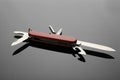 Compact portable red multitool on grey table, closeup Royalty Free Stock Photo