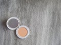 Compact powder and mirror makeup on textured background Royalty Free Stock Photo