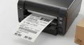 Label Printer and Shipping Box for E-commerce Logistics Royalty Free Stock Photo