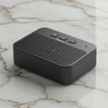 A compact, rectangular black Bluetooth speaker with a metal grille on the top surface. Royalty Free Stock Photo