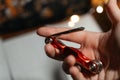 A compact red multitool resting in an open hand, showcasing its metal bits and practical design. Perfect for Royalty Free Stock Photo