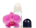 Compact roll deodorant and orchid flower on white.