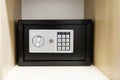 Compact safe on shelf of cabinet