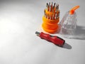 Compact screwdriver set includes a red and black handle with a textured grip. Royalty Free Stock Photo