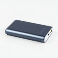 Compact, sleek power bank with a dark metallic finish, rectangular shape, Royalty Free Stock Photo