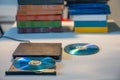 Compact stylish video player for CD and DVD disks with a pile of many TV series movie discs in background Royalty Free Stock Photo