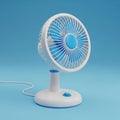 Small white and blue electric desk fan on a blue background Royalty Free Stock Photo
