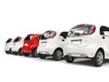 Compact white electric cars in a row - red stands out - back view