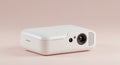Compact white projector with a sleek, rectangular design and rounded edges placed Royalty Free Stock Photo