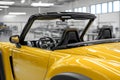 Compact yellow telehandler inside a bright industrial hall with clean modern surroundings Royalty Free Stock Photo