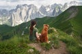 Companionable moment in the mountains. A woman and her loyal dog sit together Royalty Free Stock Photo