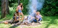 Company adult friends relaxing near campfire. Summer vacation. Friends spend leisure weekend forest nature background