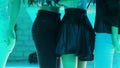 Beautiful girlfriends with slender legs hang out on disco party at nightclub