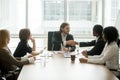 Company boss handshaking african american employee at corporate Royalty Free Stock Photo