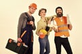 Company of cheerful workers, builder, repairer, plasterer. Man and woman with smiling faces in helmet and boilersuit Royalty Free Stock Photo