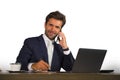 Company corporate isolated portrait of young handsome and attractive businessman working at office desk talking on mobile phone co Royalty Free Stock Photo