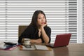 Company corporate portrait of young beautiful and busy Asian Chinese woman working busy at modern office computer desk by venetian Royalty Free Stock Photo