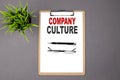 COMPANY CULTURE on the brown clipboard on the grey background. Business concept Royalty Free Stock Photo