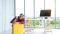 Company employees sit behind a yellow suitcase with a credit card and passport. For preparing to travel during the summer or