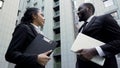 Company employees talking near office building, successful teamwork on project