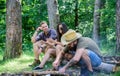 Company friends camping forest. Man brutal bearded hipster prepares bonfire in forest. Ultimate guide to bonfires