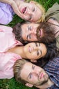Company friends lay on grass top view. Tender blonde or brutal hipster friends are on same wave. Diversity concept. They