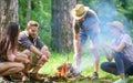 Company friends prepare roasted marshmallows snack nature background. Camping activity. Roasting marshmallows popular Royalty Free Stock Photo