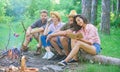 Company friends spend great time picnic or barbecue near bonfire. Group friends spend leisure weekend hike picnic forest Royalty Free Stock Photo