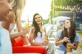 A company of good-looking friends laughing and drinking yellow cocktails in the nice cafe next to the river. Cheers