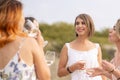 The company of gorgeous female friends having fun, drink wine, and enjoy hills landscape picnic Royalty Free Stock Photo