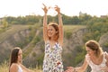 The company of gorgeous female friends having fun, drink wine, and enjoy hills landscape picnic Royalty Free Stock Photo