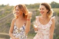 The company of gorgeous female friends having fun, drink wine, and enjoy hills landscape picnic Royalty Free Stock Photo