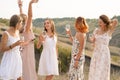 The company of gorgeous female friends having fun and enjoys a summer green hlls picnic, dancing and drink alcohol. People concept