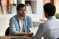 Company HR manager interviewing young male applicant at job interview Royalty Free Stock Photo