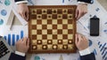 Company leaders playing chess, using business strategy to win market, top view