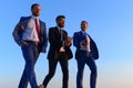 Company leaders take a walk on sunset sky background